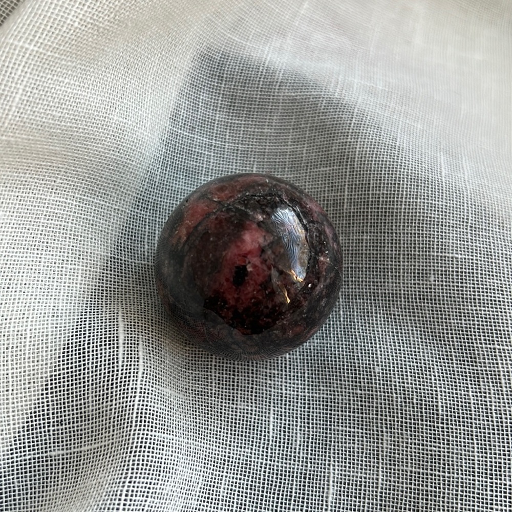 Pink and black Rhodonite sphere